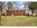 Spacious backyard with a brick home, a small deck, and ample space for outdoor activities at 616 W D Ave, Salisbury, NC 28144