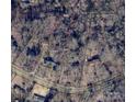 Aerial view of property showing boundaries and surrounding homes in a wooded setting near Forest Drive at 906 Forest Dr, Lancaster, SC 29720