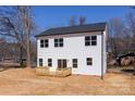 The back of the house showcases large windows and a wood deck overlooking the property at 119 Ethel Dr, Stanley, NC 28164