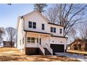 Charming two-story home featuring a bright blue front door, black garage door, and inviting front porch at 119 Ethel Dr, Stanley, NC 28164