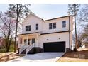 Charming two-story home featuring a bright blue front door, black garage door, and inviting front porch at 119 Ethel Dr, Stanley, NC 28164
