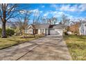 Inviting one-story home featuring a long driveway leading to an attached two-car garage at 13015 Greycrest Dr, Charlotte, NC 28278