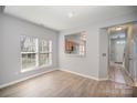Dining room with wood look flooring and natural light from the large windows at 151 Kallie Loop, Mooresville, NC 28117