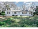 Charming single-story home with white painted brick, black shutters, and well-maintained lawn at 1601 South Point Rd, Belmont, NC 28012