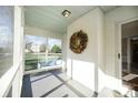 Inviting screened porch with swing, painted brick, and a leafy seasonal wreath at 1601 South Point Rd, Belmont, NC 28012