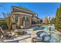 Outdoor living space with stone firepit, a pool, and a patio perfect for entertaining at 16212 Walcot Ln, Cornelius, NC 28031