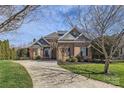 Lovely brick home featuring a well manicured front lawn, mature trees, and a paved driveway at 16212 Walcot Ln, Cornelius, NC 28031