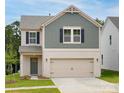 Charming two-story home featuring a brick-and-shingle exterior with a two-car garage at 1720 Coral Bark Ln # Kh15, Charlotte, NC 28216