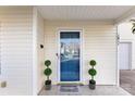 Inviting front entrance features a decorative blue door, potted plants, and a 'Welcome' sign at 1811 Endeavor Ln, Clover, SC 29710