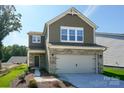 Charming two-story home with a brick-accented facade and attached two-car garage, creating an inviting curb appeal at 2005 White Cypress Ct # Kh12, Charlotte, NC 28216