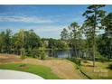 Scenic view of the lake surrounded by mature trees, showcasing a peaceful environment at 2005 White Cypress Ct # Kh12, Charlotte, NC 28216