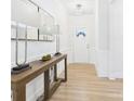 Bright foyer with wood floors, lamps, mirror and access to rooms at 2009 White Cypress Ct # Kh13, Charlotte, NC 28216