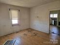 View of an empty room featuring hardwood floors and natural light from a window at 2040 S Marietta St, Gastonia, NC 28054