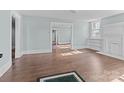 Bright living room featuring hardwood floors, and classic white trim at 208 W Lafayette St, Salisbury, NC 28144