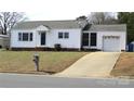 Charming single-story home with a tidy front lawn and attached garage, showcasing curb appeal at 216 Park Ridge Rd, Albemarle, NC 28001