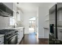 Modern kitchen featuring stainless steel appliances, white cabinetry, and a view of the backyard at 236 Victoria Ave, Charlotte, NC 28202