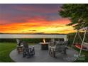 Cozy outdoor seating area with a fire pit, ideal for enjoying lake views and peaceful evenings at 2477 Peninsula Shores Ct, Denver, NC 28037