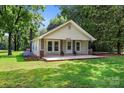 Charming single-story home featuring a welcoming front porch, manicured lawn, and mature trees at 28419 Nc Hwy 73 Hwy, Albemarle, NC 28001