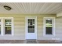 A well lit covered front porch with detailed front door at 28419 Nc Hwy 73 Hwy, Albemarle, NC 28001