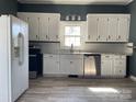 Bright kitchen featuring white cabinets, stainless steel appliances, and updated countertops at 3481 Roberta Rd, Concord, NC 28027