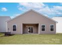 Spacious backyard with lush green grass, ideal for outdoor activities and relaxation, and a sliding door into the home at 3606 Clover Valley Dr, Gastonia, NC 28052