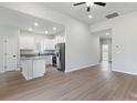 Open-concept living room and kitchen area with wood-look flooring, stainless steel appliances, and ample natural light at 3606 Clover Valley Dr, Gastonia, NC 28052