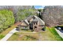 Beautiful aerial view of the two-story home with manicured lawn, brick facade and mature trees at 6548 Robin Hollow Dr, Mint Hill, NC 28227