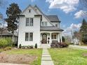 Charming two-story home with landscaped yard, stone walkway and covered porch at 700 Clement Ave, Charlotte, NC 28204