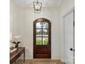 Bright foyer featuring a wood-look door with glass panes and an elegant light fixture at 700 Clement Ave, Charlotte, NC 28204