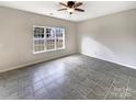 Spacious room with large window and tile flooring, ready for your personal touch at 7829 Buddy Holly Rd, Charlotte, NC 28216