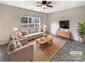 Bright living room with neutral tones and a large window for natural light at 7829 Buddy Holly Rd, Charlotte, NC 28216