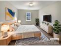 Cozy main bedroom with a bed, neutral colors, and decor to make it feel like home at 7829 Buddy Holly Rd, Charlotte, NC 28216