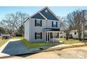 Gray sided two-story home featuring a small porch and simple landscaping at 81 Kirk St, Salisbury, NC 28144