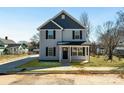 Charming two-story home featuring gray siding, black shutters, and a welcoming front porch at 81 Kirk St, Salisbury, NC 28144