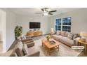 This staged living room is freshly painted and features neutral decor, stylish furniture and a ceiling fan with light at 845 Finley Rd, Rock Hill, SC 29730