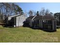 Spacious townhouse with gray siding, balconies, and lawn in a community setting at 9129 Troon Ln # C, Charlotte, NC 28214