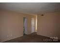 Bright living room with neutral walls, carpet flooring and view to doorway at 9129 Troon Ln # C, Charlotte, NC 28214