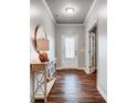 Elegant entryway featuring hardwood floors, stylish console table, and a glass-paneled front door at 9325 Beecroft Valley Dr, Huntersville, NC 28078