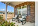 Inviting front porch with rocking chairs, perfect for enjoying peaceful outdoor moments at 9325 Beecroft Valley Dr, Huntersville, NC 28078