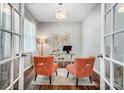 Bright home office with French doors, modern desk, and comfortable seating, ideal for remote work at 9325 Beecroft Valley Dr, Huntersville, NC 28078