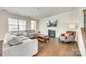 Spacious living room featuring a fireplace, hardwood floors, and neutral decor at 10014 Berkeley Castle Dr, Charlotte, NC 28273