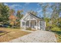Charming one-story home showcasing a covered porch, driveway, and well-kept landscaping at 1006 W B St, Kannapolis, NC 28081