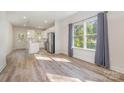 Bright, open-concept living space with hardwood floors adjacent to the kitchen at 1006 W B St, Kannapolis, NC 28081