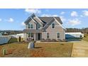 Beautifully landscaped two-story home with a welcoming front porch and well-maintained lawn at 1010 Coppergate Dr, Salisbury, NC 28147