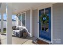 Inviting front porch featuring comfortable seating and a stylish blue door with a wreath at 1010 Coppergate Dr, Salisbury, NC 28147