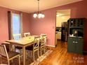 Inviting dining room with hardwood floors, a view of the kitchen, and ample natural light at 105 Old Bridge Ct, Gastonia, NC 28056