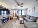 Bright living room featuring a corner sofa, modern fireplace, and stylish decor at 108 Oak Grove St, Kannapolis, NC 28081