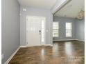 Welcoming foyer with wood-look flooring and natural light coming through the front door at 10826 Saltmarsh Ln, Charlotte, NC 28278