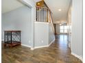 Open-concept foyer showcasing wood-look flooring, staircase, and seamless transition to living spaces at 10826 Saltmarsh Ln, Charlotte, NC 28278
