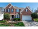 Traditional brick home with well-maintained landscaping and a two-car garage at 11001 Valley Spring Dr, Charlotte, NC 28277